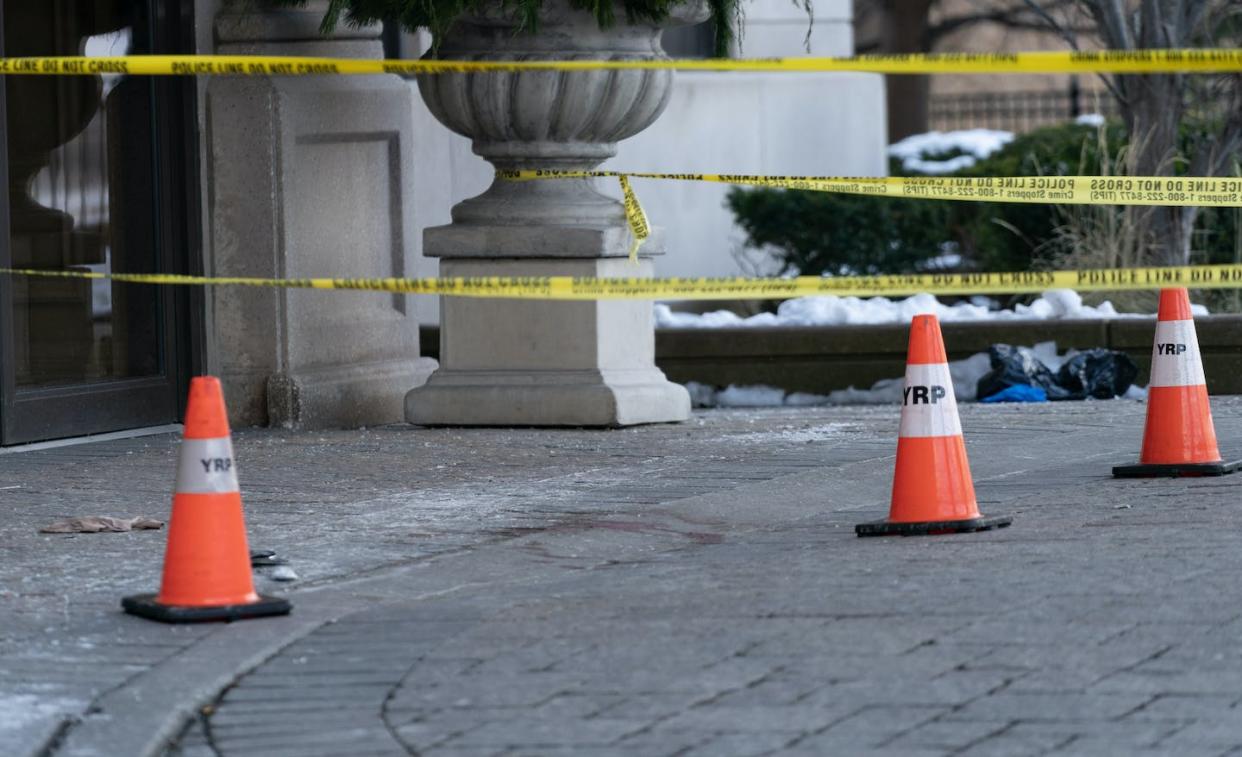 Police cones and tape are seen outside of a condominium building the day after a shooting in Vaughan, Ont. THE CANADIAN PRESS/Arlyn McAdorey