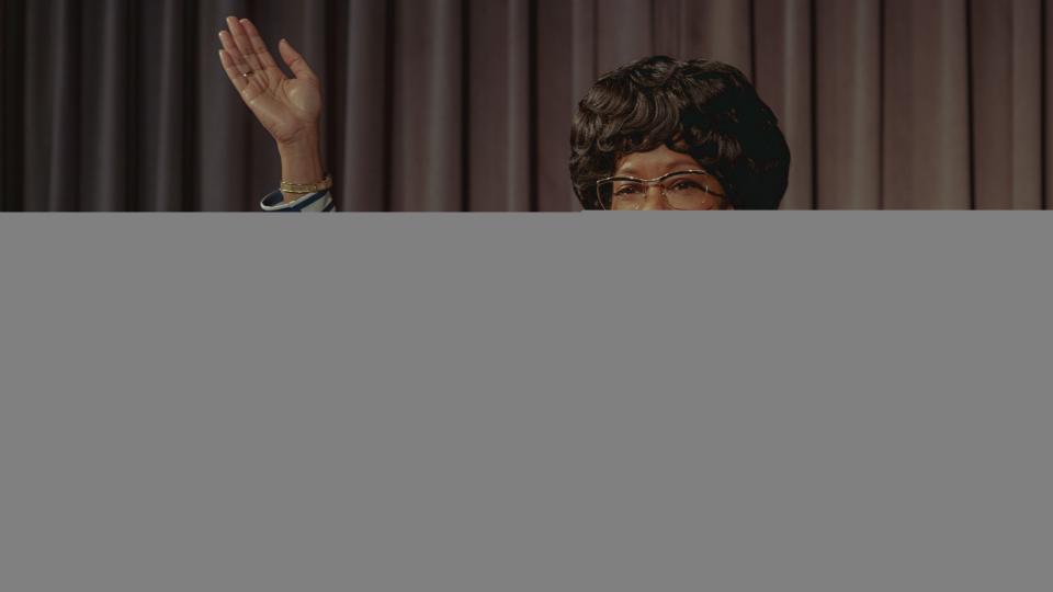 Regina King as Shirley Chisholm behind a podium in Shirley