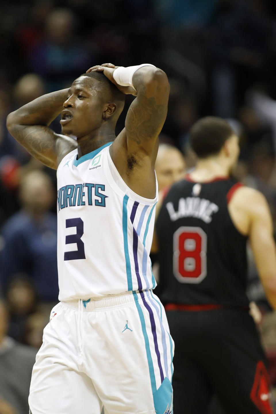 Charlotte Hornets' Terry Rozier (3) makes his way off the court as Chicago Bulls' Zach LaVine (8) celebrates a victory in an NBA basketball game in Charlotte, N.C., Saturday, Nov. 23, 2019. (AP Photo/Bob Leverone)