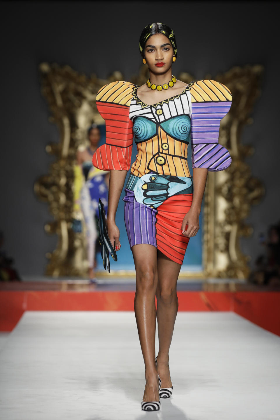 A model wears a creation as part of the Moschino Spring-Summer 2020 collection, unveiled during the fashion week, in Milan, Italy, Thursday, Sept. 19, 2019. (AP Photo/Luca Bruno)