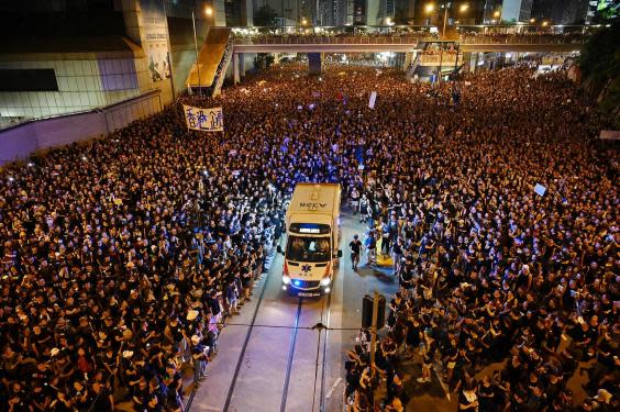 (Image showing the crowd part to let an ambulance through. AFP/Getty)