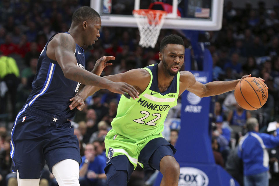 Dallas Mavericks forward Dorian Finney-Smith (10) guards Minnesota Timberwolves forward Andrew Wiggins (22) in the first quarter of an NBA basketball game Wednesday, Dec. 4, 2019, in Dallas. (AP Photo/Richard W. Rodriguez)