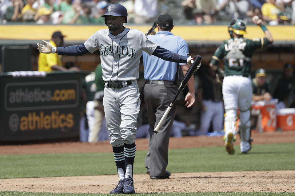 Seattle Mariners' Dee Gordon reacts after striking out against the Oakland Athletics during the fifth inning of a baseball game in Oakland, Calif., Wednesday, Aug. 15, 2018. (AP Photo/Jeff Chiu)