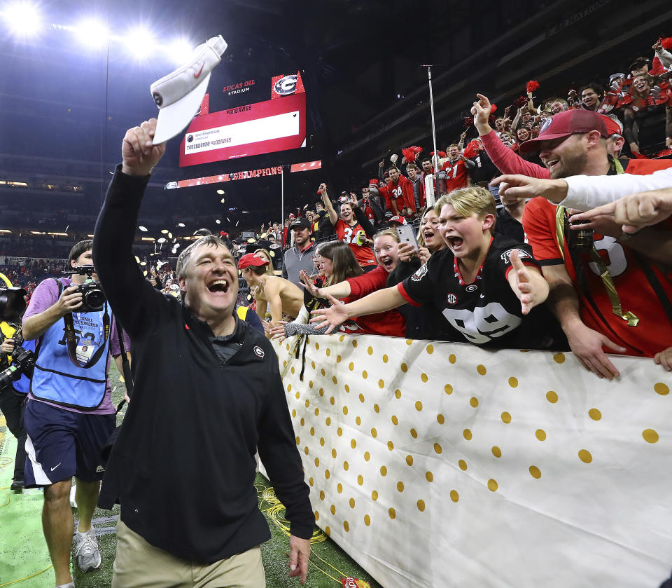 Georgia head coach Kirby Smart celebrates with fans after beating Alabama 33-18 in the College Football Playoff championship game, early Tuesday, Jan. 11, 2022, in Indianapolis. (Curtis Compton/Atlanta Journal-Constitution via AP)