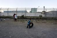 A child plays with a tyre outside the Topo Chico prison in Monterrey, Mexico, February 11, 2016. REUTERS/Daniel Becerril