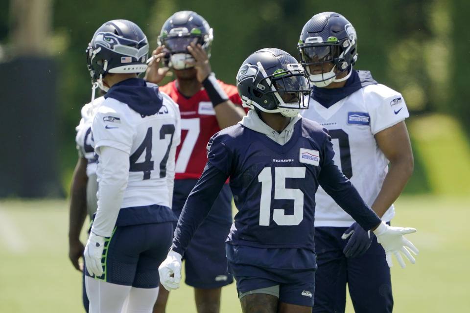 Seattle Seahawks wide receiver Marquise Goodwin (15) reaches out to greet teammates during NFL football practice Monday, May 23, 2022, in Renton, Wash. (AP Photo/Ted S. Warren)