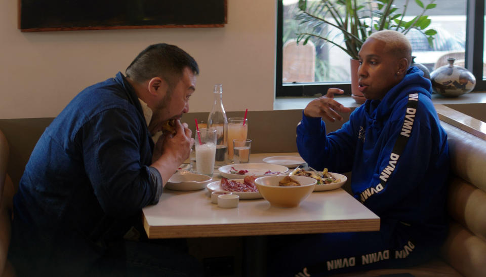 This image released by Netflix shows David Chang, left, and Lena Waithe having breakfast at Winsome in Los Angeles in a scene from the Netflix series, "Breakfast, Lunch & Dinner." (Netflix via AP)