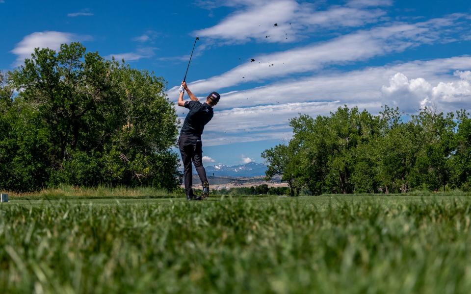 Professional golfer Jeremy Paul tees off on the scenic par-3 eighth during the final round of The Ascendant at TPC Colorado in Berthoud on July 3, 2022.