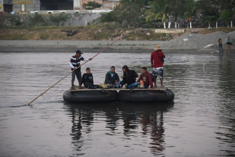 Honduran migrants heading to the United States in a caravan cross the Suchiate River, the natural border between Guatemala and Mexico, in makeshift rafts without waiting for humanitarian visas offered by Mexico