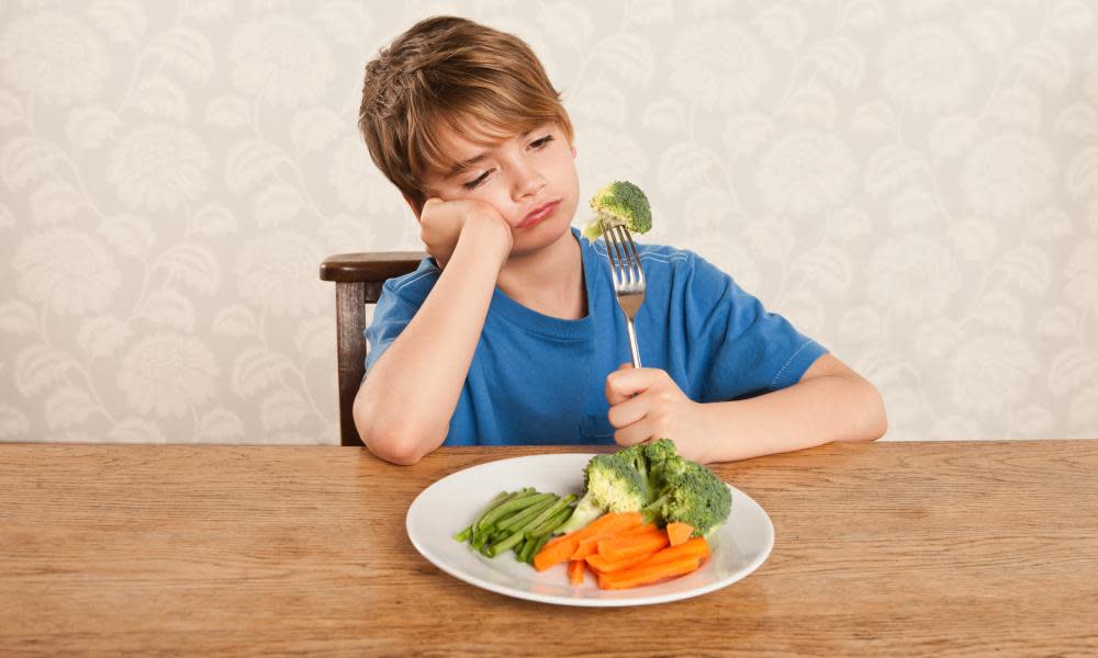 Boy frowning at vegetables