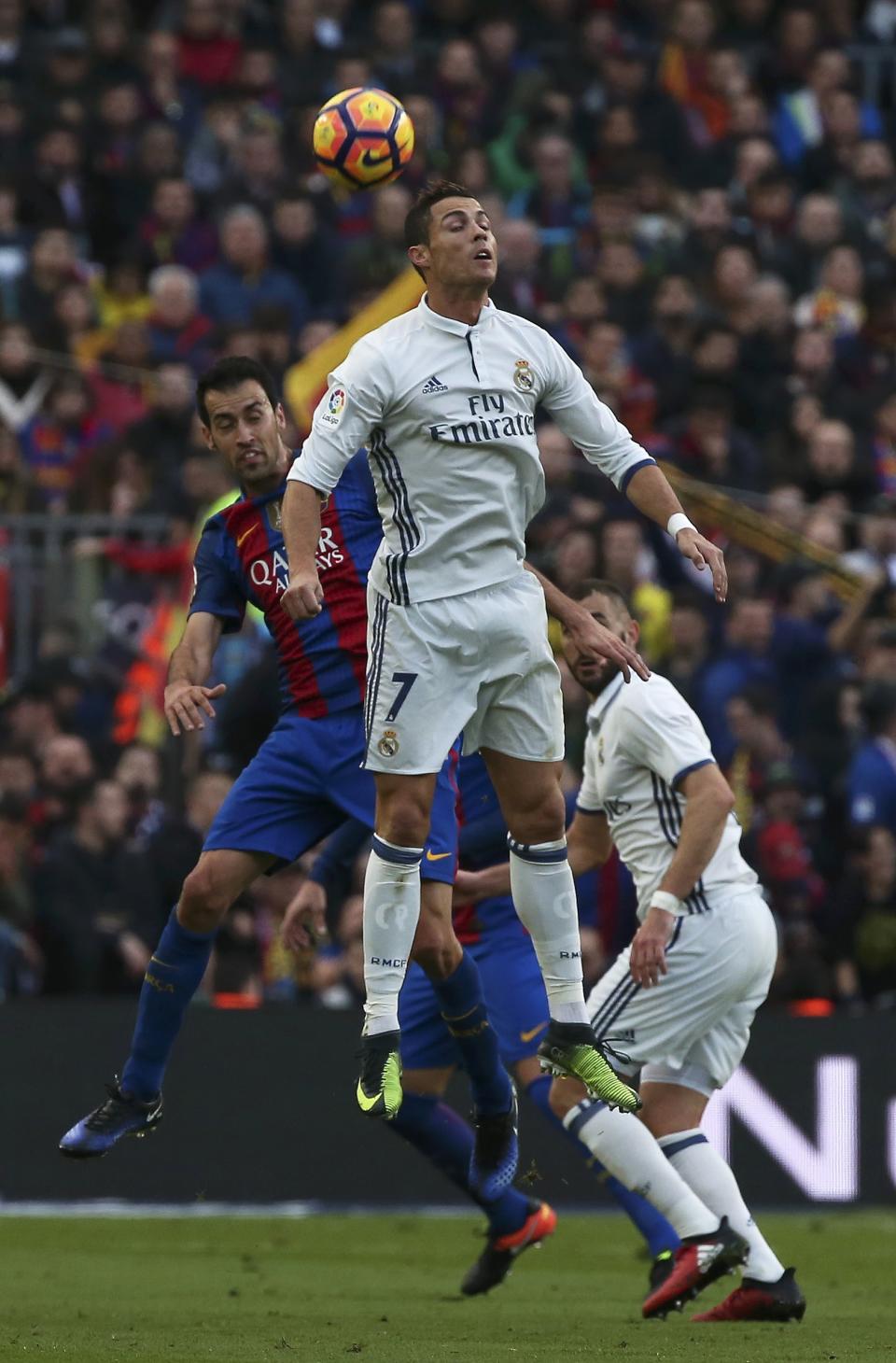 Football Soccer - Barcelona v Real Madrid - Spanish La Liga Santander- Nou Camp Stadium, Barcelona, Spain - 3/12/16. Real Madrid's Cristiano Ronaldo and Barcelona's Sergio Busquets in action during the "Clasico". REUTERS/Sergio Perez