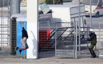 <p>A fan throws a chair at a riot police officer during clashes before the Greek Cup Final soccer game between PAOK Salonika and AEK Athens at Panthessaliko stadium in Volos, Greece, May 6, 2017. (Photo: Nikos Vichos/Intimenews/Reuters) </p>