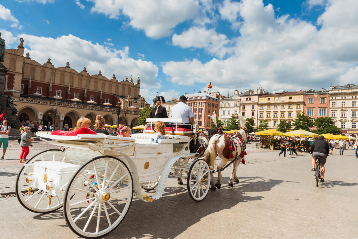 A horse and carriage carries tourists in Krakow, Poland