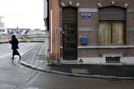 A woman walks along a street called "Rue du Fort" in Charleroi, Belgium, January 13, 2016. REUTERS/Francois Lenoir