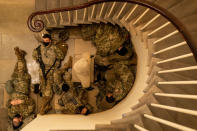 WASHINGTON, DC - JANUARY 13: Members of the National Guard sleep in the halls of Capitol Hill as the House of Representativs convene to impeach President Donald Trump, nearly a week after a pro-Trump insurrectionist mob breached the security of the nations capitol while Congress voted to certify the 2020 Election Results on Wednesday, Jan. 13, 2021 in Washington, DC. (Kent Nishimura / Los Angeles Times via Getty Images)