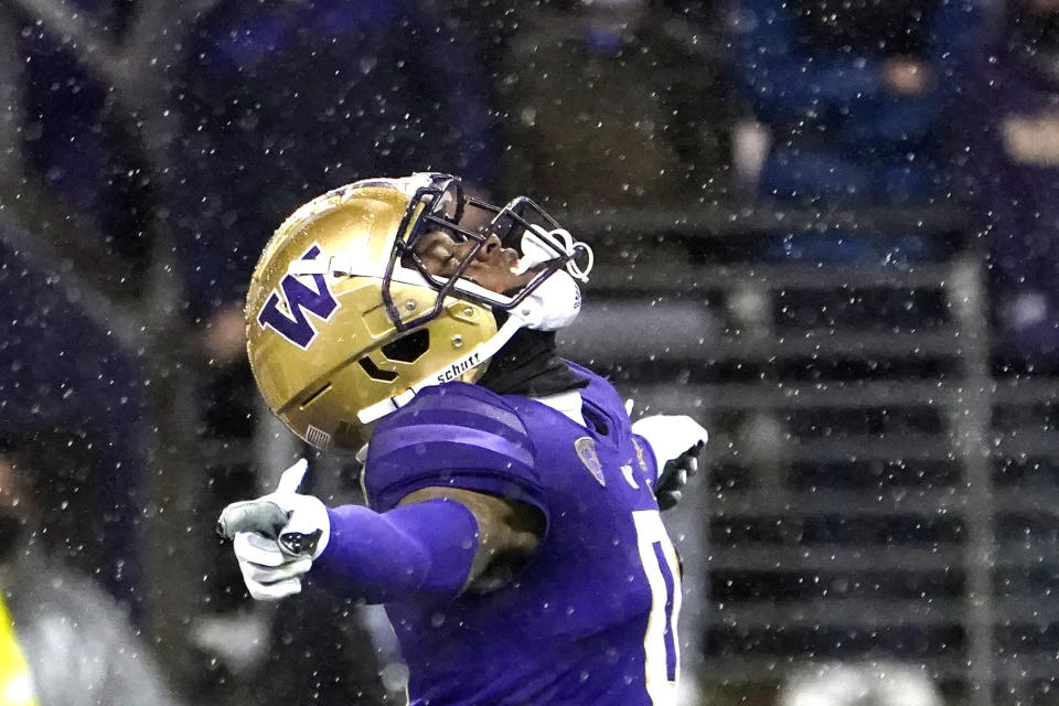 Washington's Giles Jackson signals as the ball goes into the end zone on a kick by Arizona State in the rain during the second half of an NCAA college football game on Nov. 13, 2021, in Seattle. Seattle, a city known for soggy weather, has seen its wettest fall on record. The National Weather Service says 19.04 inches of rain fell in the period between Sept. 1 and Nov. 30, breaking a record set in 2006. (AP Photo/Elaine Thompson, File)