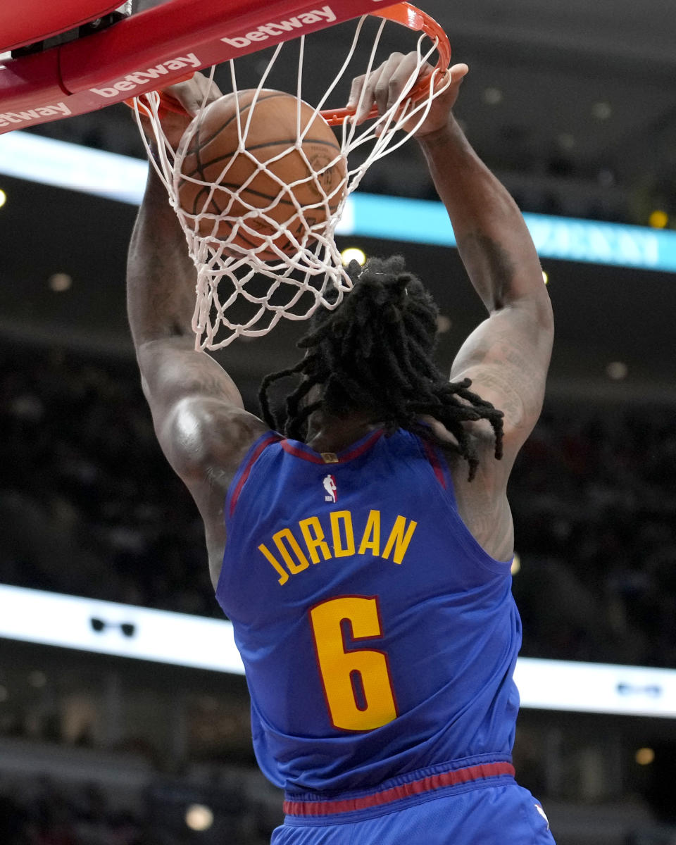 Denver Nuggets center DeAndre Jordan makes a reverse dunk during the first half of an NBA basketball game against the Chicago Bulls Tuesday, Dec. 12, 2023, in Chicago. (AP Photo/Charles Rex Arbogast)