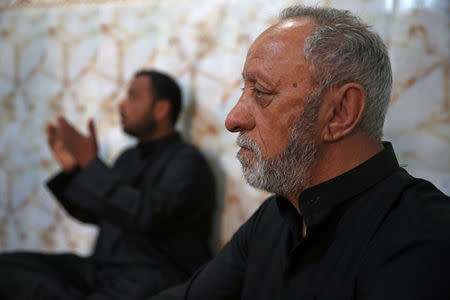 Kashawi Jari, father of Walid al-Abidi, and Bassem, brother of Saad Khudair Abbas, who were killed with a group of youth by Islamic State militants at Kirkuk road, are seen during the interview with Reuters in Kerbala, Iraq July 5, 2018. Picture taken July 5, 2018. REUTERS/Abdullah Dhiaa al-Deen