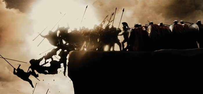 The Spartans driving their enemies off a cliff with the sun shining in the background in "300"