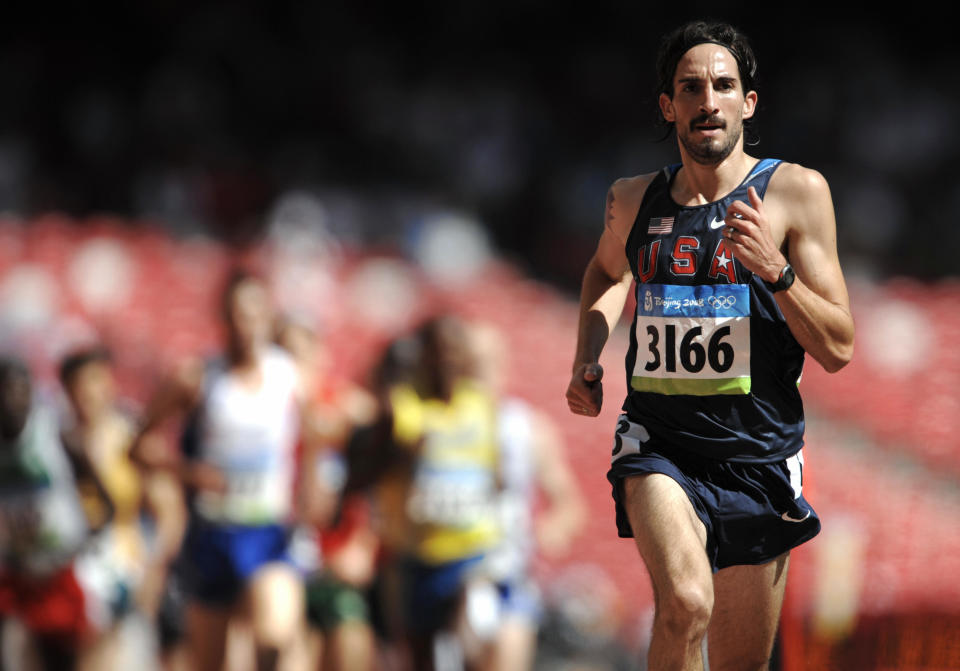 Anthony Famiglietti, a two-time Olympian steeplechaser, appeared to run a sub-four minute mile at age 40 with a dog by his side last Saturday. (OLIVIER MORIN/AFP/Getty Images)