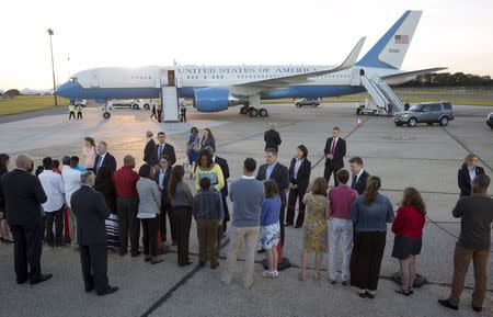 U.S. first lady Michelle Obama speaks with wellwishers at Stansted Airport, southern England June 15, 2015. REUTERS/Neil Hall