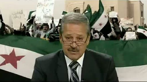 Syrian Ambassador to Iraq Nawaf Fares, seen here reading a statement on July 11, in which he announced his defection to the Syrian opposition, in video shown on YouTube on July 12. Pressure mounted on Syrian President Bashar al-Assad on Thursday after Fares became the first senior diplomat to defect and Western powers drew up a 10-day sanctions ultimatum