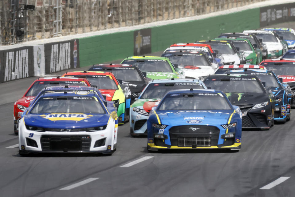 Cars race toward the first turn during the first stage of the NASCAR Quaker State 400 auto race at Atlanta Motor Speedway on Sunday, July 10, 2022, in Hampton, Ga. (Miguel Martinez/Atlanta Journal-Constitution via AP)