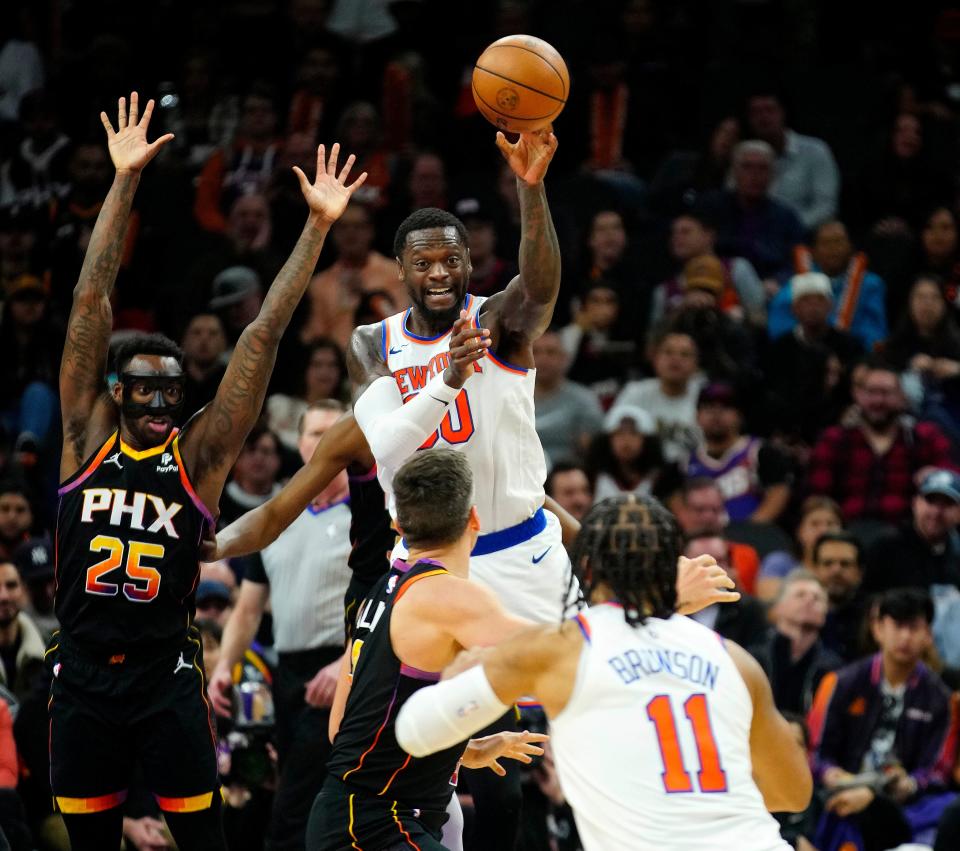 December 15, 2023; Phoenix, Ariz.; USA; Knicks foward Julius Randle (30) passes away from the defense of Suns wing Nassir Little (25) during a game at the Footprint Center.