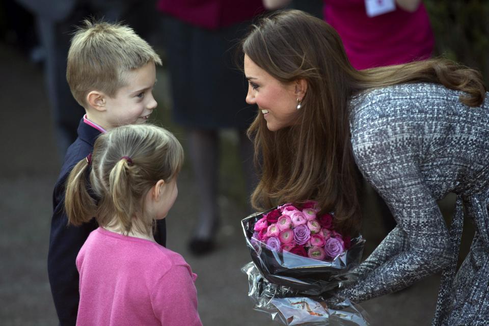 Britain's Kate, The Duchess of Cambridge receives flowers, as she leaves after a visit to Hope House, in London, Tuesday, Feb. 19, 2013. As patron of Action on Addiction, the Duchess was visiting Hope House, a safe, secure place for women to recover from substance dependence. (AP Photo/Matt Dunham)