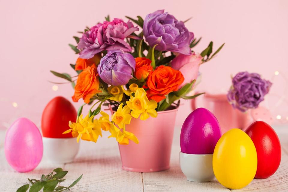 bouquet of flowers next to colorful plastic eggs