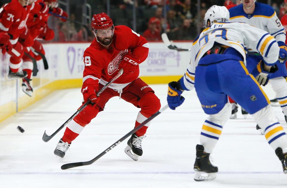 Detroit Red Wings center Sam Gagner (89) passes the puck against Buffalo Sabres defenseman Colin Miller (33) during the first period of an NHL hockey game Saturday, Nov. 27, 2021, in Detroit.