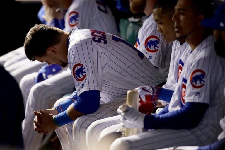Kyle Schwarber of the Chicago Cubs sits in the dugout in the ninth inning against the Los Angeles Dodgers during game five of the National League Championship Series, at Wrigley Field in Chicago, Illinois, on October 19, 2017