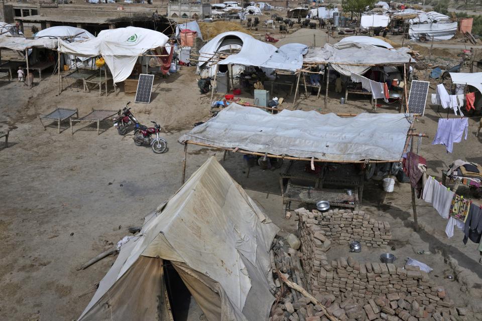 Solar panels help power a washing machine and other necessities in Ismail Khan Khoso village in Sohbatpur, a district of Pakistan's Baluchistan province, Thursday, May 18, 2023. In rural areas of Baluchistan, only those who saved their solar panels from the flooding have access to electricity to keep the cool in the summer heat. (AP Photo/Anjum Naveed)