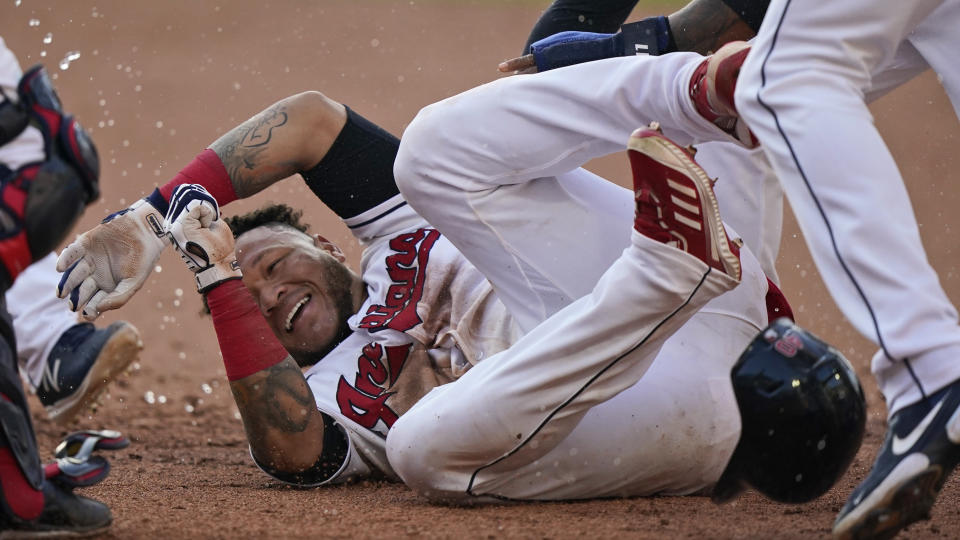 Cleveland Indians' Harold Ramirez is mobbed by teammates after they defeated the Seattle Mariners in 10 innings in a baseball game, Saturday, June 12, 2021, in Cleveland. (AP Photo/Tony Dejak)