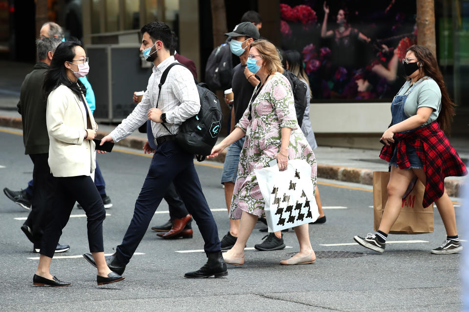 Pedestrians are seen wearing masks in the Brisbane CBD Tuesday, September 28, 2021. Source: AAP