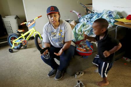 FILE PHOTO - A'Kendra Erving speaks to a reporter in her home with her son, King Erving, 3, in East Chicago, Indiana, U.S. September 16, 2016. REUTERS/Michelle Kanaar/File Photo