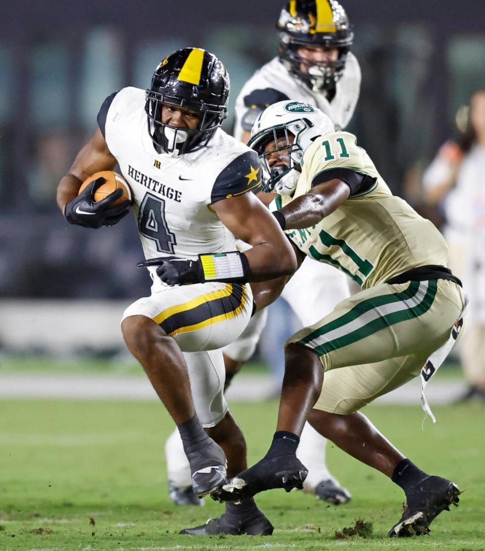 American Heritage running back Mark Fletcher (4) earns a first down as Miami Central’s Zayden Laing-Taylor (11) makes the tackle in the first quarter during the 2022 FHSAA State Championships-Class 2M at DRV PNK Stadium in Ft. Lauderdale on Friday, December 16, 2022.