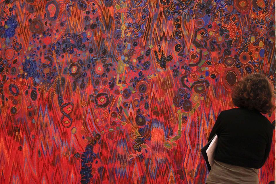 A woman looks to the artwork Untitled (Venice) created in 1967 by Lee Mullican during a press preview of the exhibition 'Pacific Standard Time' in Berlin, Wednesday, March 14, 2012. An exhibition that offers viewers a primer on three decades of Los Angeles' art scene and stems from a decade of research is opening in Berlin, Thursday, March 15. (AP Photo/Markus Schreiber)