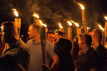 White nationalists carry torches on the grounds of the University of Virginia, on the eve of a planned Unite The Right rally in Charlottesville, Virginia, U.S. August 11, 2017. Alejandro Alvarez/News2Share via REUTERS