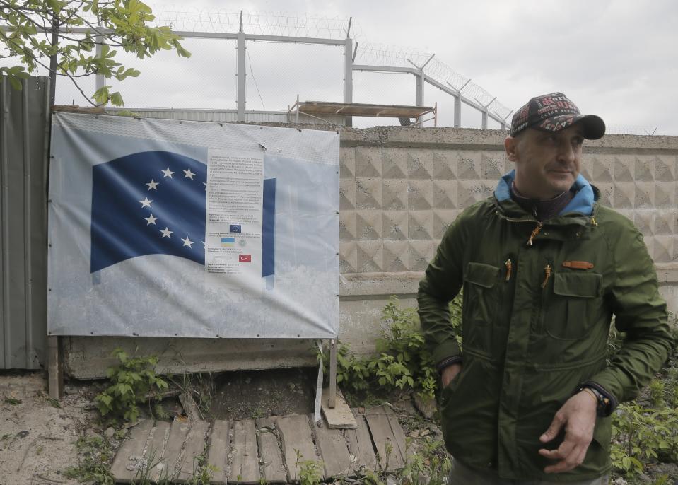 In this photo taken Tuesday, April 29, 2014, deputy head of the construction site, Volodymyr Pashchenko, supervises work on the construction of a detention center in Zhdanivka, near Donetsk, Ukraine. Moscow calls the detention center under construction near the Russian border a “fascist concentration camp.” Inside the barbed-wire fences, the reality is less ominous: It’s an EU-funded project to hold asylum seekers and illegal immigrants, similar to countless detention centers across Europe. (AP Photo/Efrem Lukatsky)