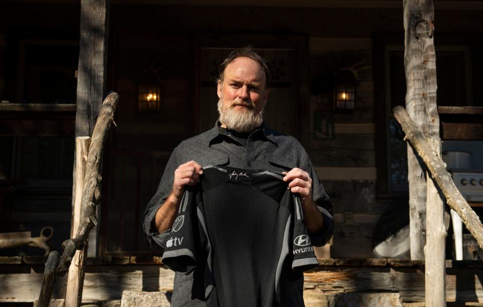 John Carter Cash holds up the Johnny Cash inspired 2023 soccer jersey, at the Cash Cabin in Hendersonville , Tenn., Friday, Jan. 27, 2023.