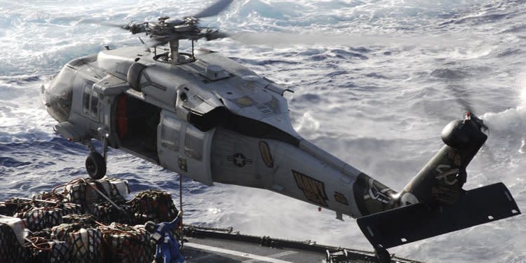 A MH-60S helicopter assigned to the Golden Falcons of Helicopter Sea Combat Squadron (HSC) 12 lands on the flight deck of the Nimitz-class aircraft carrier USS John C. Stennis (CVN 74)