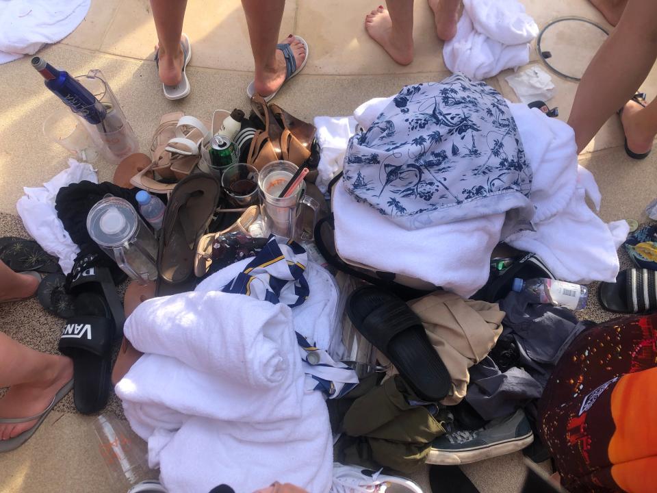 Shoes, towels, empty cups and clothing line the pool at Tao Beach Dayclub at The Venetian casino resort in Las Vegas. It costs $30 a day to rent a locker at the dayclub.