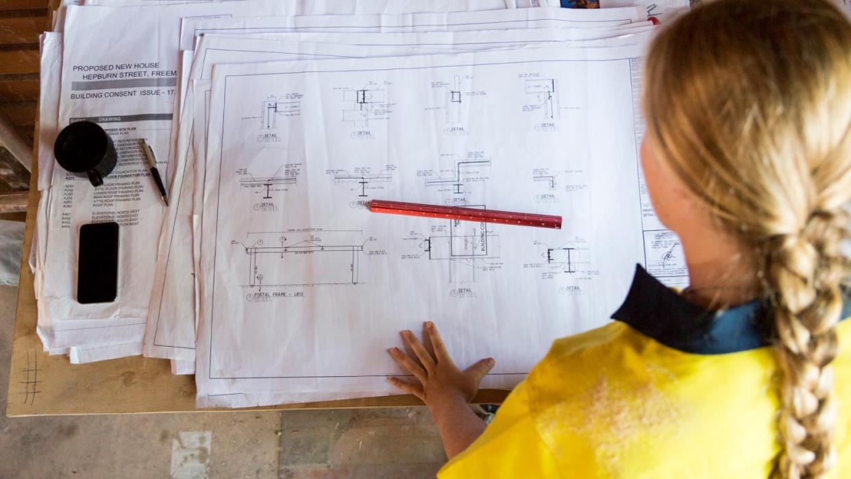Female construction worker looking at site plans