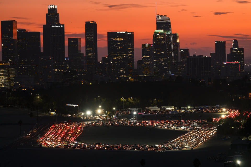 Motorists wait in lines to take a coronavirus test in a parking lot at Dodger Stadium, Monday, Jan. 4, 2021, in Los Angeles. (AP Photo/Ringo H.W. Chiu)