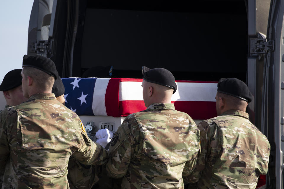 An Army carry team loads a transfer case containing the remains of U.S. Army Sgt. 1st Class Michael Goble, Wednesday, Dec. 25, 2019, at Dover Air Force Base, Del. According to the Department of Defense, Goble, of Washington Township, N.J., assigned to the 7th Special Forces Group, died while supporting Operation Freedom's Sentinel. (AP Photo/Alex Brandon)