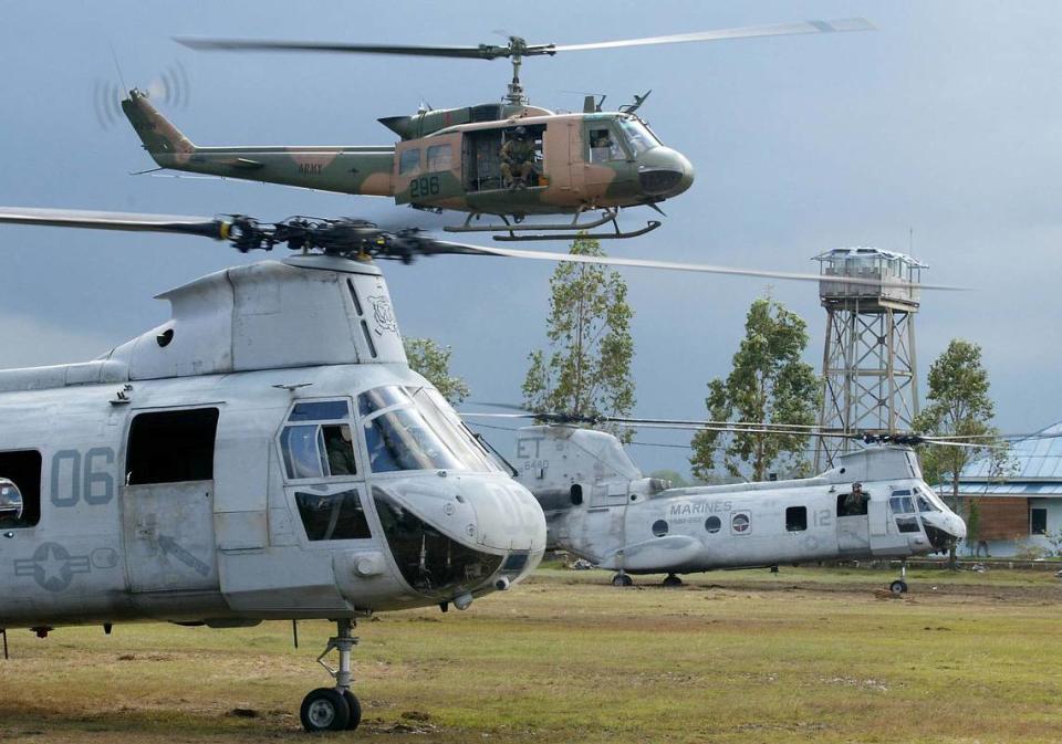 A Bell UH-1 Huey helicopter, top, is seen with United States Marine Chinook helicopters in Indonesia in 2005 after a tsunami.