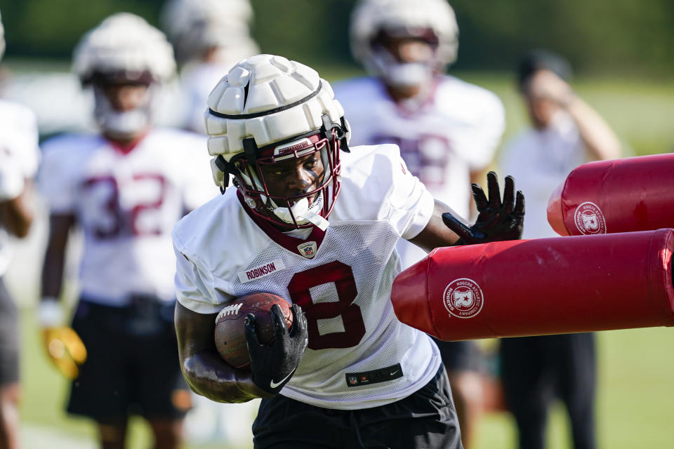 Washington Commanders running back Brian Robinson runs a drill during practice at the team's NFL football training facility, Wednesday, Aug. 10, 2022, in Ashburn, Va. (AP Photo/Alex Brandon)