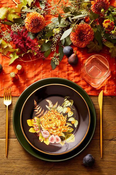 <p>For a vintage take on the orange-and-gold color scheme, choose some pretty floral plates, skinny gold flatware, and a bright orange runner. </p><p><a class="link " href="https://www.amazon.com/Grelucgo-Handmade-Hemstitch-Thanksgiving-Decorations/dp/B07BFZ5WDX?tag=syn-yahoo-20&ascsubtag=%5Bartid%7C10070.g.23289609%5Bsrc%7Cyahoo-us" rel="nofollow noopener" target="_blank" data-ylk="slk:SHOP ORANGE TABLE RUNNER;elm:context_link;itc:0;sec:content-canvas">SHOP ORANGE TABLE RUNNER</a></p>