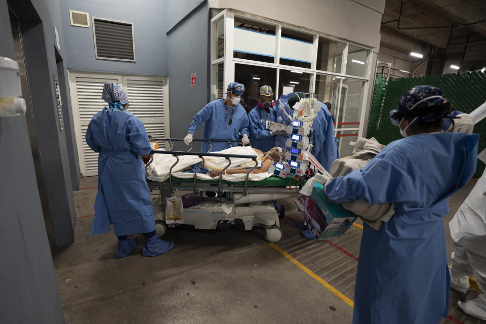 Health workers bring in a gravely ill patient at the Ajusco Medio General Hospital which is designated for COVID-19 cases only, in Mexico City, Tuesday, Aug. 31, 2021. (AP Photo/Marco Ugarte)